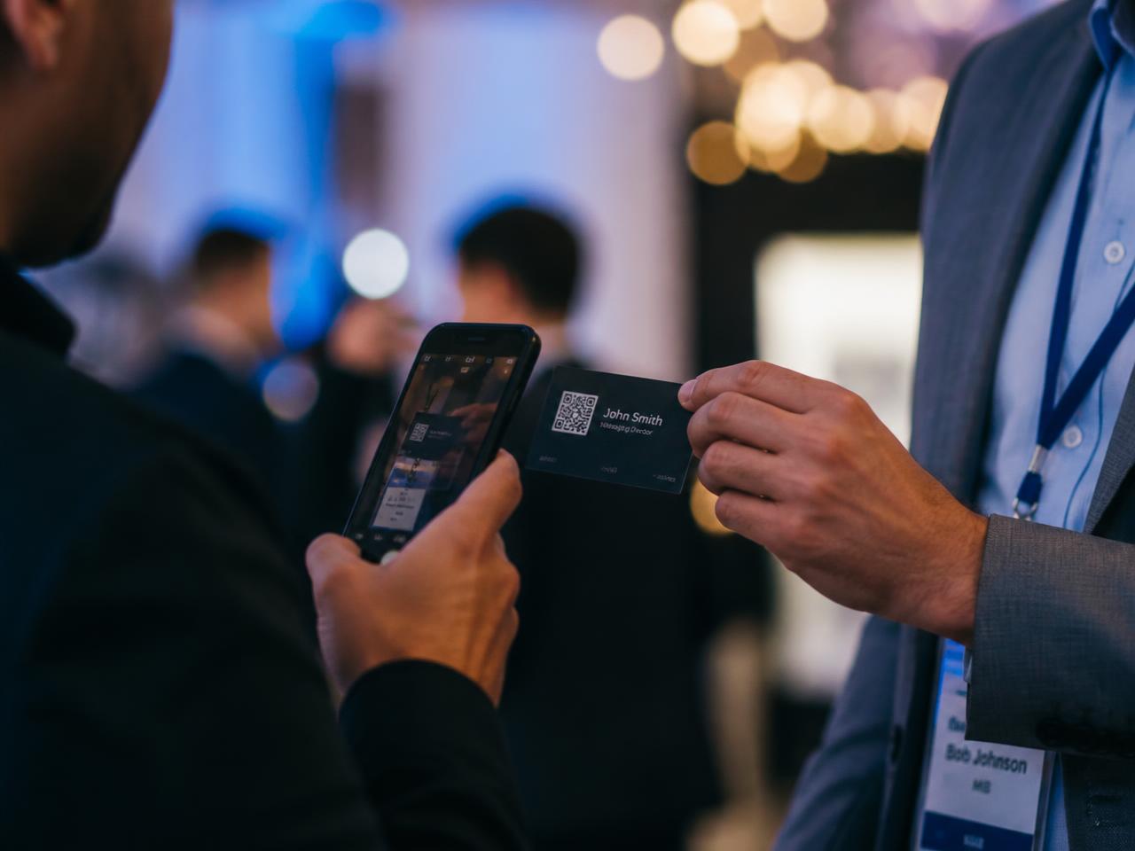 Professional scanning a QR code on a business card at a networking event